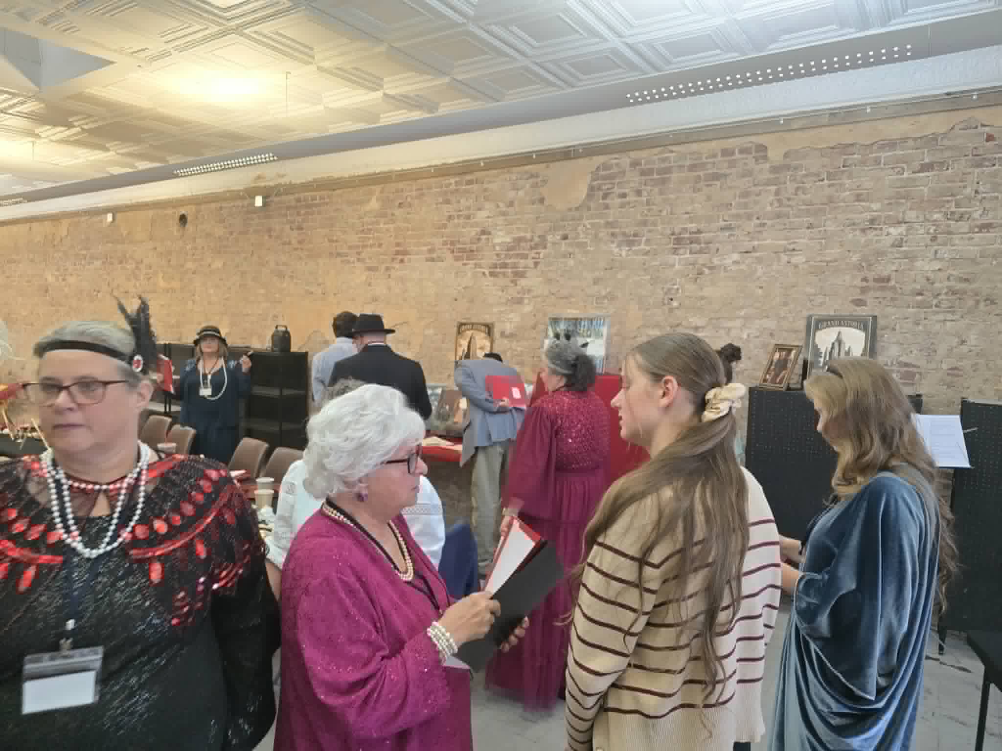 Guests mingling along the brick wall, trading theories between courses.